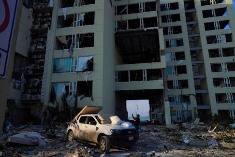 A man takes photos of a damaged hotel, in the aftermath of Hurricane Otis in Acapulco, Mexico, October 27, 2023.