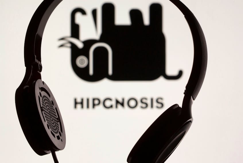 A headset is seen in front of displayed Hipgnosis logo in this illustration taken, June 28, 2021.