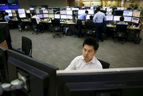 A currency dealer works at a dealing room of a bank in Seoul, South Korea, August 25, 2015.   