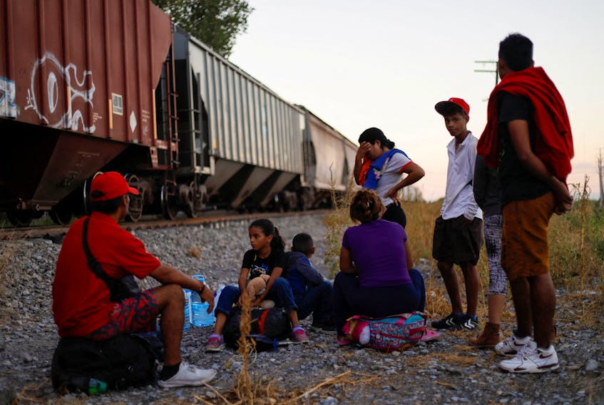 Venezuelan migrants wait to board a train to try to reach the U.S. border, as they travel through the state of Nuevo Leon, in San Nicolas de los Garza, Mexico September 19, 2023.