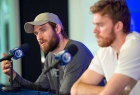 Leon Draisaitl, left, and Connor McDavid of the Edmonton Oilers speak with media at Rogers Place in Edmonton on May 16, 2023.
