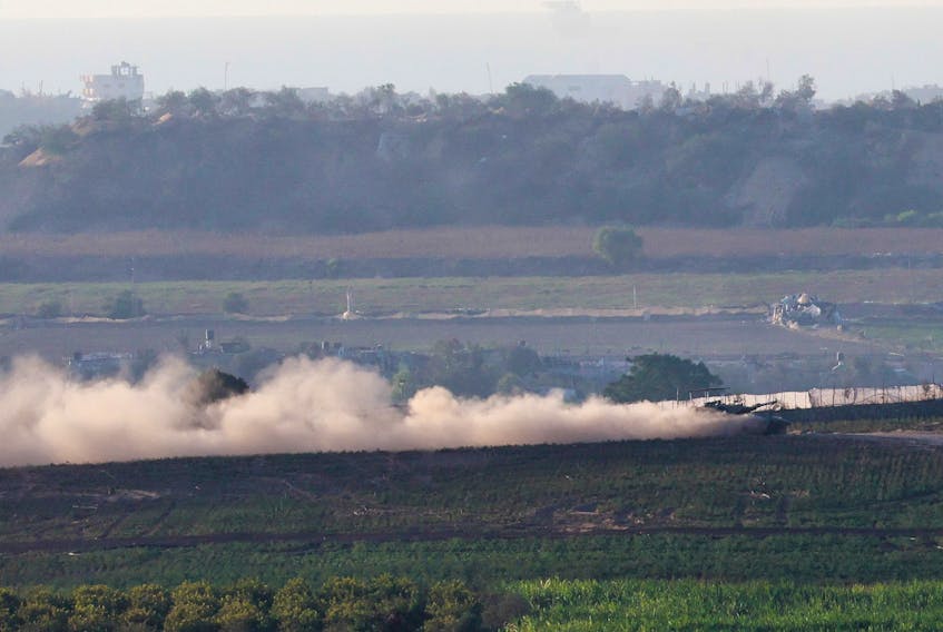 A tank manoeuvres at the border between Israel and the Gaza strip, amid the ongoing conflict between Israel and Palestinian Islamist group Hamas, as seen from Sderot in southern Israel, November 7, 2023.