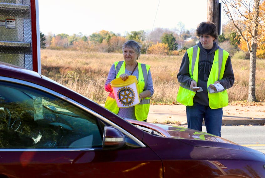 Judy Rockwell and Patrick Tremblay volunteered their time on Oct. 28 to help collect change at the Windsor Rotary Club’s toll road.
