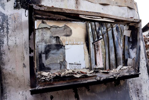 A Hanukkiyah, a candlestick used during the Jewish holiday of Hanukkah, stands on the remains of a burnt windowsill, following a deadly infiltration by Hamas gunmen from the Gaza Strip, in Kibbutz Be'eri in southern Israel, October 17, 2023.