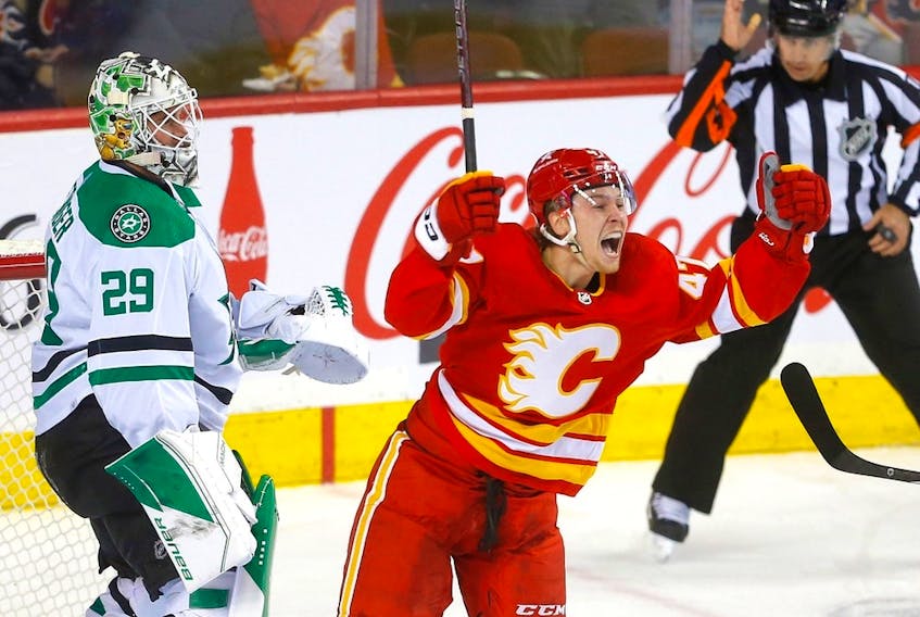  Calgary Flames forward Connor Zary celebrates after scoring his first NHL goal, against Dallas Stars goaltender Jake Oettinger at Scotiabank Saddledome in Calgary on Wednesday, Nov. 1, 2023.
