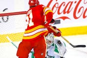 Calgary Flames Nazem Kadri battles Dallas Stars goalie Jake Oettinger in first-period NHL action at the Scotiabank Saddledome in Calgary on Wednesday, November 1, 2023.