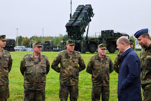 German Chancellor Olaf Scholz meets with members of the Patriot air defense missile system unit as he visits the Cologne-Bonn Air Force base to attend a demonstration of the capabilities of the Territorial Command of the German army Bundeswehr in Wahn, a suburb of Cologne, Germany, October 23, 2023. 