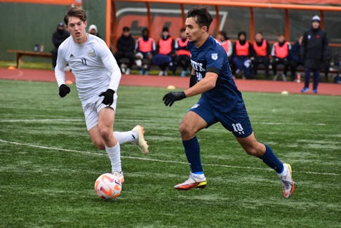 Kyle Cordeiro of the St. Francis Xavier X-Men, right, works his way up the field as he’s pressured by Brennan Fuerst of the University of British Columbia Thunderbirds during U Sports Men’s Soccer Championship action at Ness Timmons Field in Sydney on Thursday.