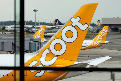 Scoot and Singapore Airlines planes sit on the tarmac at Singapore's Changi Airport March 23, 2020. 