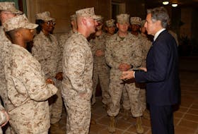 U.S. Secretary of State Antony Blinken exchanges challenge coins with the U.S. Marine Corps embassy security guard detachment in Baghdad, Iraq, November 5, 2023.