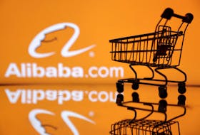 Shopping trolley is seen in front of Alibaba logo in this illustration, July 24, 2022.