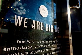 A help wanted sign at a store along Queen Street West in Toronto Ontario, Canada June 10, 2022.