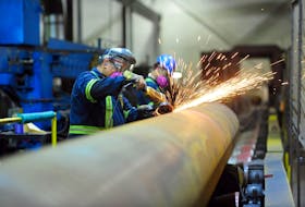 Workers are seen at Bri-Steel Manufacturing, a manufacturer and distributer of large diameter seamless steel pipes, in Edmonton, Alberta, Canada June 21, 2018.
