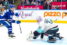 Toronto Maple Leafs' Mitchell Marner scores against Seattle Kraken goaltender Philipp Grubauer during second period NHL hockey action in Toronto on Thursday, Nov. 30, 2023.