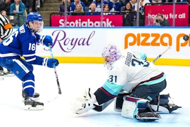 Toronto Maple Leafs' Mitchell Marner scores against Seattle Kraken goaltender Philipp Grubauer during second period NHL hockey action in Toronto on Thursday, Nov. 30, 2023.