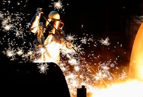A worker controls a tapping of a blast furnace at Europe's largest steel factory of Germany's industrial conglomerate ThyssenKrupp AG in the western German city of Duisburg December 6, 2012.