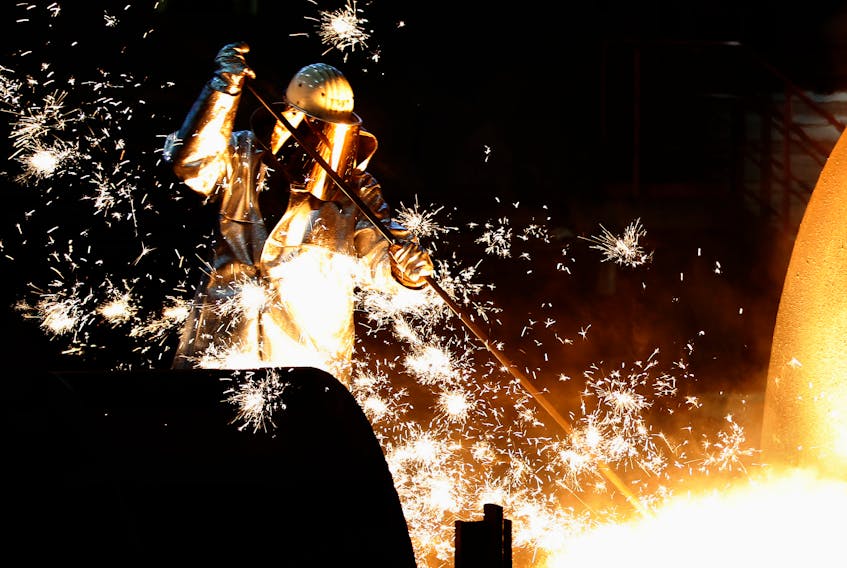 A worker controls a tapping of a blast furnace at Europe's largest steel factory of Germany's industrial conglomerate ThyssenKrupp AG in the western German city of Duisburg December 6, 2012.