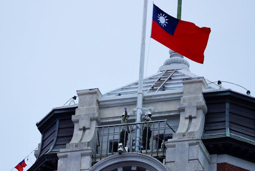 Honor guards raise a Taiwanese flag at the Presidential Palace ahead of the National Day celebration ceremony in Taipei, Taiwan October 10, 2023.