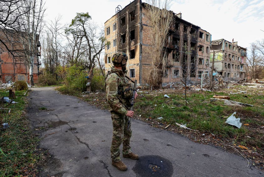 A Ukrainian serviceman stands next to residential buildings heavily damaged by permanent Russian military strikes in the front line town of Avdiivka, amid Russia's attack on Ukraine, in Donetsk region, Ukraine November 8, 2023. Radio Free Europe/Radio Liberty/Serhii Nuzhnenko via REUTERS