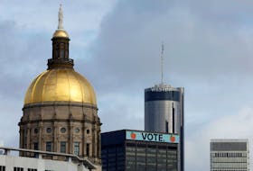 A general view of the Atlanta skyline includes the Georgia Capitol dome and a "Vote" sign atop the 100 Peachtree building, days ahead of nationally significant U.S. Senate and state governor elections in Atlanta, Georgia, U.S. November 6, 2022. 