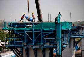 Labourers work at a construction site of the Ahmedabad-Mumbai High Speed Rail corridor in Ahmedabad, India, May 31, 2023.