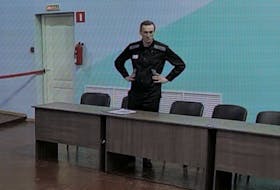 Russian opposition politician Alexei Navalny appears on a screen via video link before an external hearing of the Moscow City Court in the criminal case against him on numerous charges, including the creation of an extremist organization, at the IK-6 penal colony in Melekhovo in the Vladimir region, Russia, August 4, 2023.
