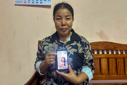 Bunyarin Srijan, the mother of a Thai hostage released as part of a hostages-prisoners swap deal between Hamas and Israel, holds her phone showing an image of her daughter, Natthawaree Mulkan, during an interview at her home in Khon Kaen, Thailand November 25, 2023.