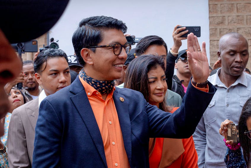 Madagascar's President and a presidential candidate Andry Rajoelina flanked by his wife Mialy Rajoelina as he arrives to cast his ballot at a polling station, during the presidential election in Ambatobe, Antananarivo, Madagascar November 16, 2023.