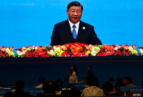 Journalists watch a giant screen broadcasting footage of Chinese President Xi Jinping speaking at the opening ceremony of the Third Belt and Road Forum (BRF), at the media centre in Beijing, China October 18, 2023.