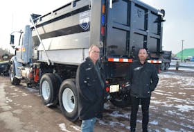 Graham Miner, left, director of highway safety, and Stephen Szwarc, director of highway maintenance, say the province is changing to flashing blue and amber on its snow-clearing equipment. The red light pictured does not flash. Dave Stewart • The Guardian