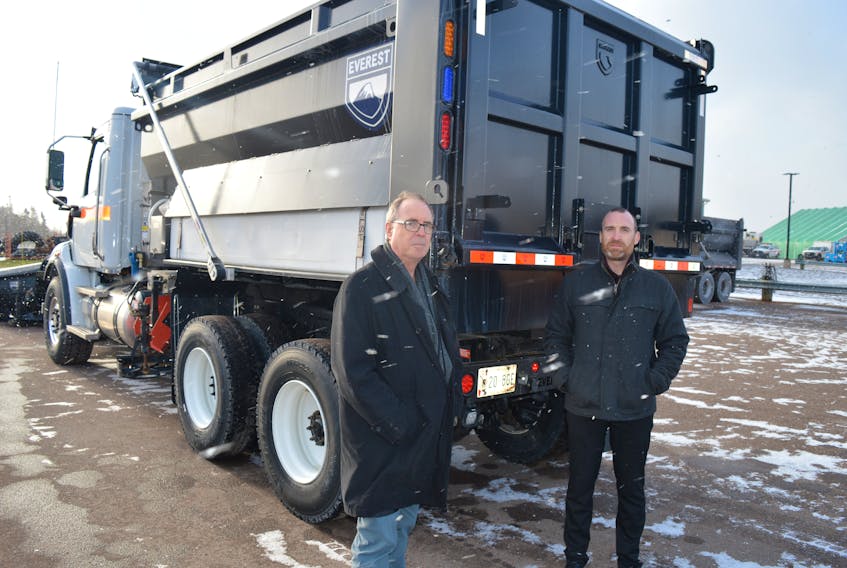 Graham Miner, left, director of highway safety, and Stephen Szwarc, director of highway maintenance, say the province is changing to flashing blue and amber on its snow-clearing equipment. The red light pictured does not flash. Dave Stewart • The Guardian