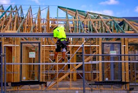 A tradesman works on the roof of a house under construction at a housing development located in the western Sydney suburb of Oran Park in Australia, October 21, 2017. Picture taken October 21, 2017.
