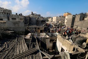 Palestinians inspect the site of Israeli strikes on houses after a temporary truce between Palestinian Islamist group Hamas and Israel expired, in Khan Younis in the southern Gaza Strip, December 1, 2023.