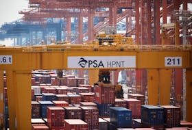A giant crane moves a shipping container at Pusan Newport Terminal in Busan, South Korea, July 1, 2021.