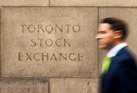 A man walks past an old Toronto Stock Exchange (TSX) sign in Toronto, June 23, 2014. Canada's main stock index was little changed on Monday as weakness in financial and energy shares offset gains in the materials sector.  