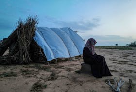 A 15-year-old victim of sexual violence in El Geneina, West Darfur, is seen outside a makeshift shelter in Adre, Chad, August 1, 2023.