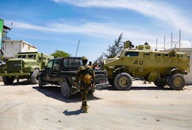 African Union peacekeepers stand next to armoured personnel carriers (APC) as they provide security for members of the Lower House of Parliament who are meeting to elect a speaker, at the Aden Adde International Airport in Mogadishu, Somalia, April 27, 2022.