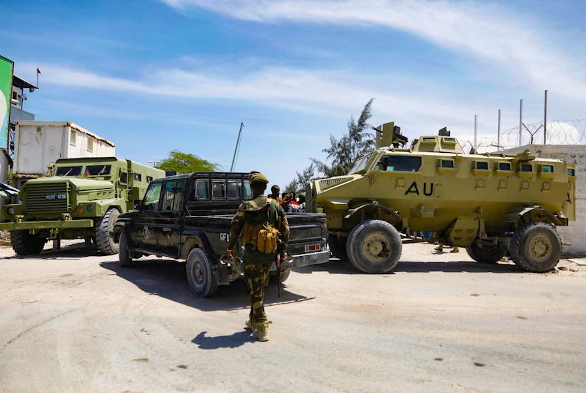 African Union peacekeepers stand next to armoured personnel carriers (APC) as they provide security for members of the Lower House of Parliament who are meeting to elect a speaker, at the Aden Adde International Airport in Mogadishu, Somalia, April 27, 2022.