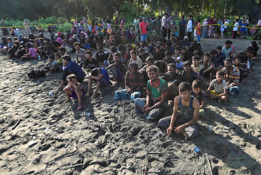 Rohingya Muslims rest on a beach after they land in Blang Raya, Pidie, Aceh province, Indonesia, December 10, 2023.