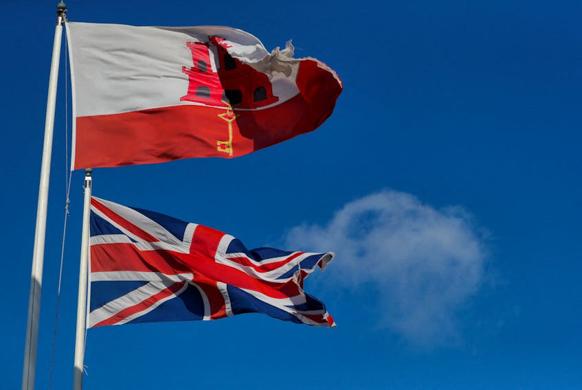 The Gibraltarian and Britain's Union Jack flags fly at the border between Spain and Gibraltar, January 1, 2021.