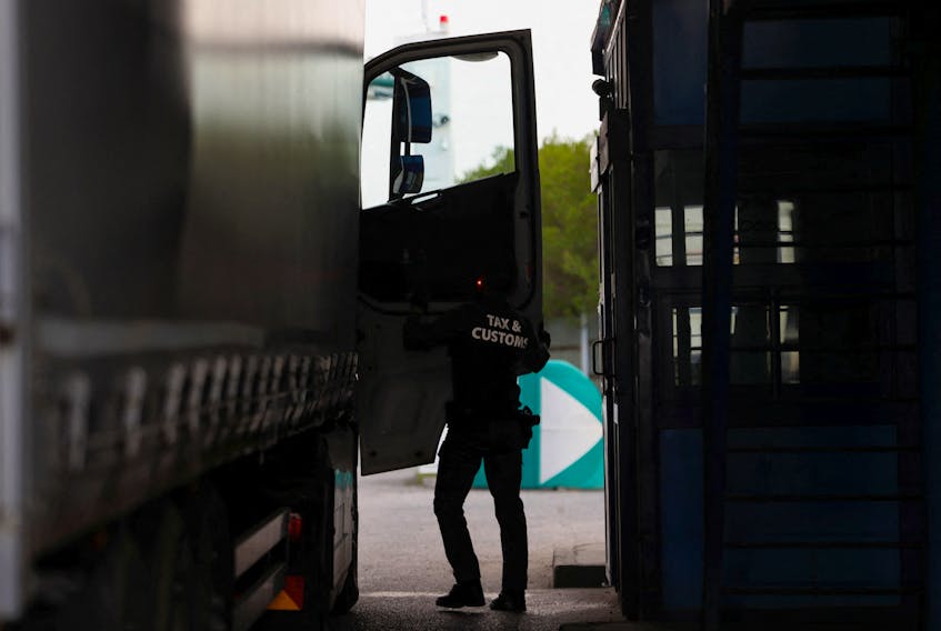 A member of the Tax and Customs Directorate checks an Ukrainian truck at the Hungarian-Ukrainian border, in Zahony, Hungary, April 19, 2023.