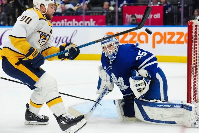 Maple Leafs goaltender Ilya Samsonov makes a save on Predators forward Ryan O'Reilly during third period NHL action in Toronto, Saturday, Dec. 9, 2023.