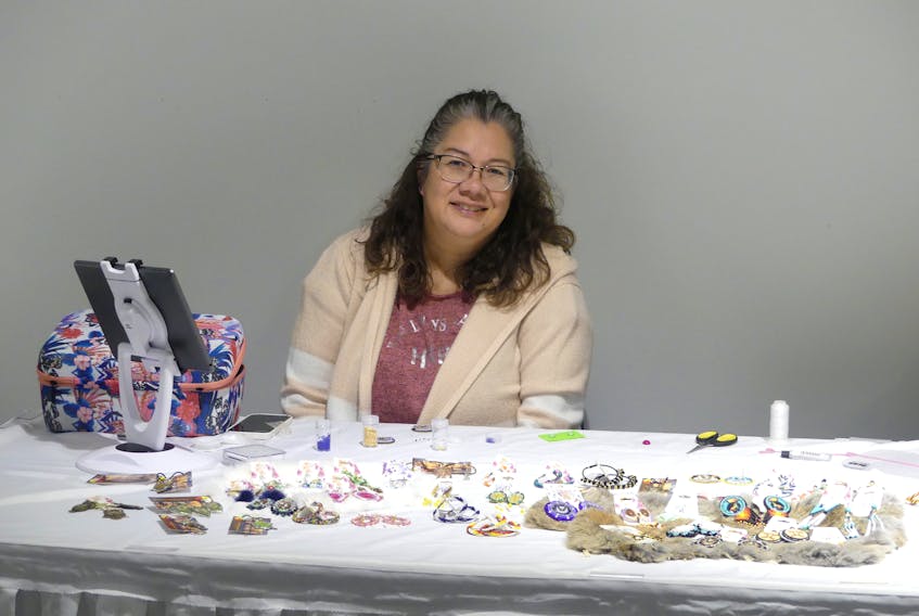 Tracy Stevens of Ainsley's Mi'kmaq Creations sold hand-beaded earrings, ornaments, and more at the 2nd annual Mi'kmaw Christmas Market in the loft space at the Cape Breton Centre for Craft and Design on Wednesday. Stevens's beading business, which opened its doors in We'koqma'q First Nation only a month ago, is named for Stevens' late grandson, Ainsley, who passed away in infancy. "The name will keep his memory going on; every time someone asks me about the name, I get to tell them about him." The Wednesday event celebrated Indigenous artists, artisans and crafters and was described as a unique shopping experience for both Mi'kmaw and non-Mi'kmaw communities. Fifteen artists based in Unama'ki displayed their crafts, which ranged from contemporary to traditional handmade items. 
The market also featured an array of beadwork, visual art, jewelry, and sculpture, along with body care products and more. Ash basketry, woodworking, clothing like ribbon skirts and ribbon pants were also among the traditional crafts found by visitors. MITCHELL FERGUSON/CAPE BRETON POST