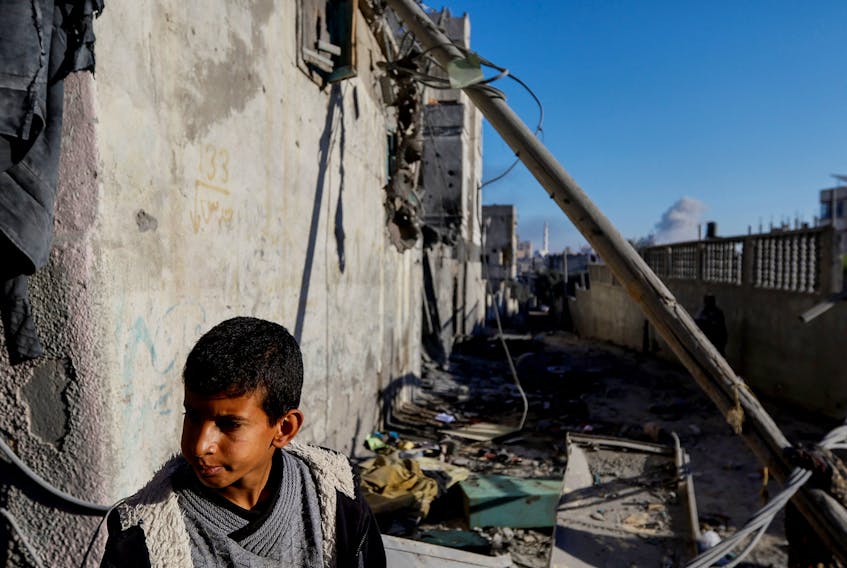 A Palestinian boy reacts after an Israeli strike on a house, amid the ongoing conflict between Israel and Palestinian Islamist group Hamas, in Khan Younis in the southern Gaza Strip, December 9, 2023.