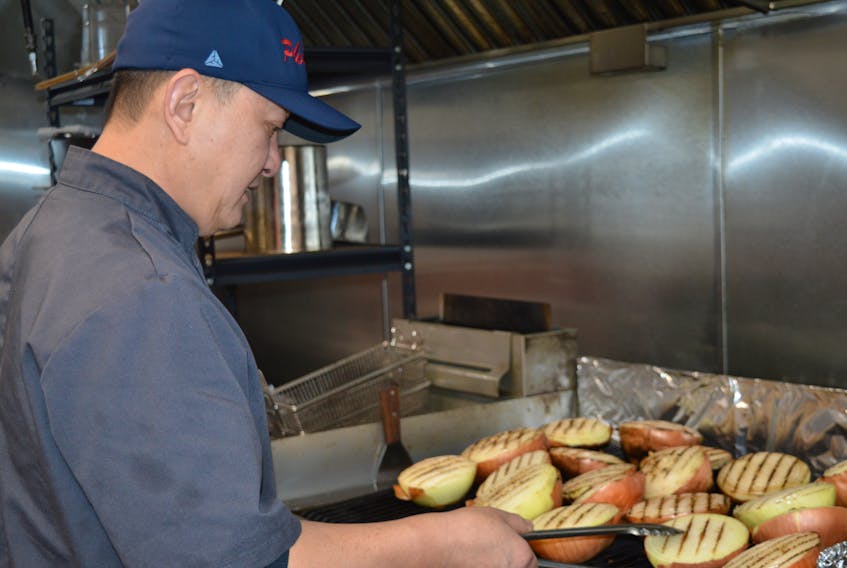 Andy Dao grills onions for one of his dishes at the Vietnamese restaurant Pho 72 in Sydney. BARB SWEET/CAPE BRETON POST