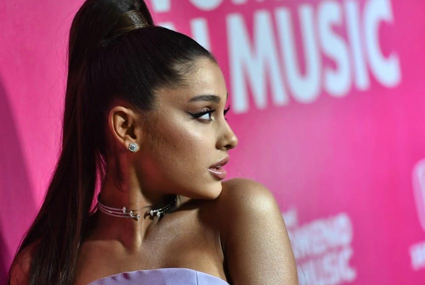 Two Christmas songs by Ariana Grande have made the naughty list when it comes to workplace distraction.