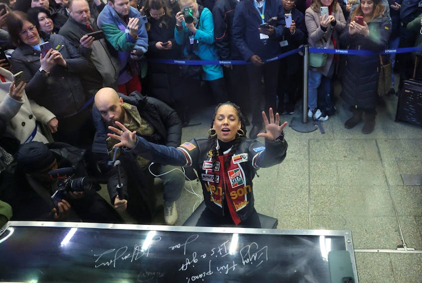 Singer Alicia Keys gives a surprise performance on Elton John's piano at St. Pancras International Station in London, Britain, December 11, 2023.