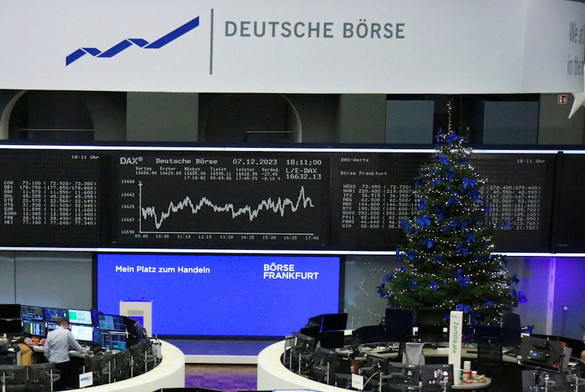 A Christmas tree stands in front of the German share price index DAX graph at the stock exchange in Frankfurt, Germany, December 7, 2023.   