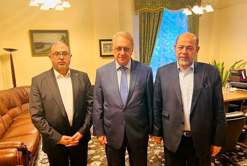 Senior Hamas officials Bassem Naim and Moussa Abu Marzouk, and Russia's Deputy Foreign Minister Mikhail Bogdanov meet for talks on the release of foreign hostages, at a location given as Moscow, Russia in this handout image released on October 26, 2023.   Hamas Handout/Handout via