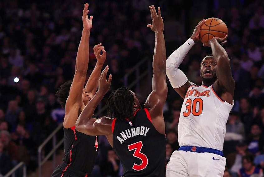 Julius Randle #30 of the New York Knicks shoots against O.G. Anunoby #3 of the Toronto Raptors during their game at Madison Square Garden on December 11, 2023 in New York City.